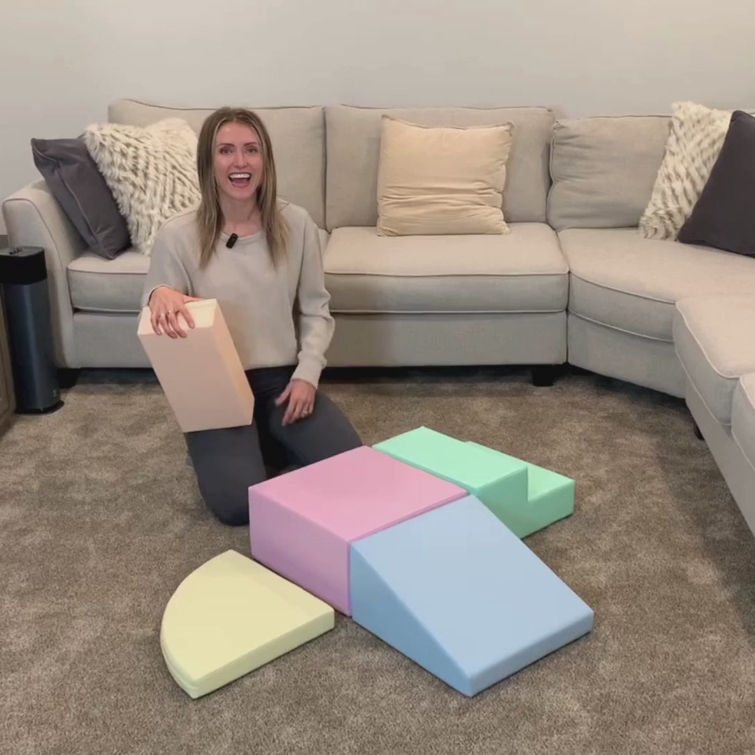 Toddler jumping on blue-gray pastel foam block showing non-slip surface