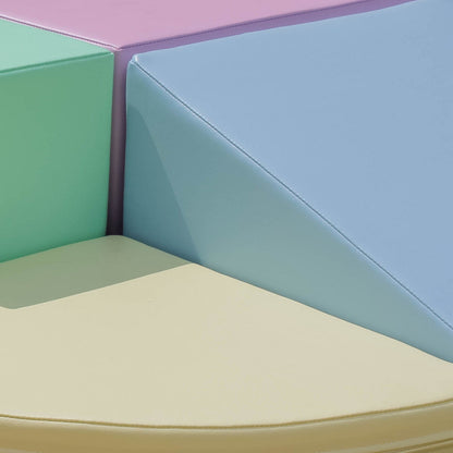 Child playing with toys on stacked light pastel foam blocks