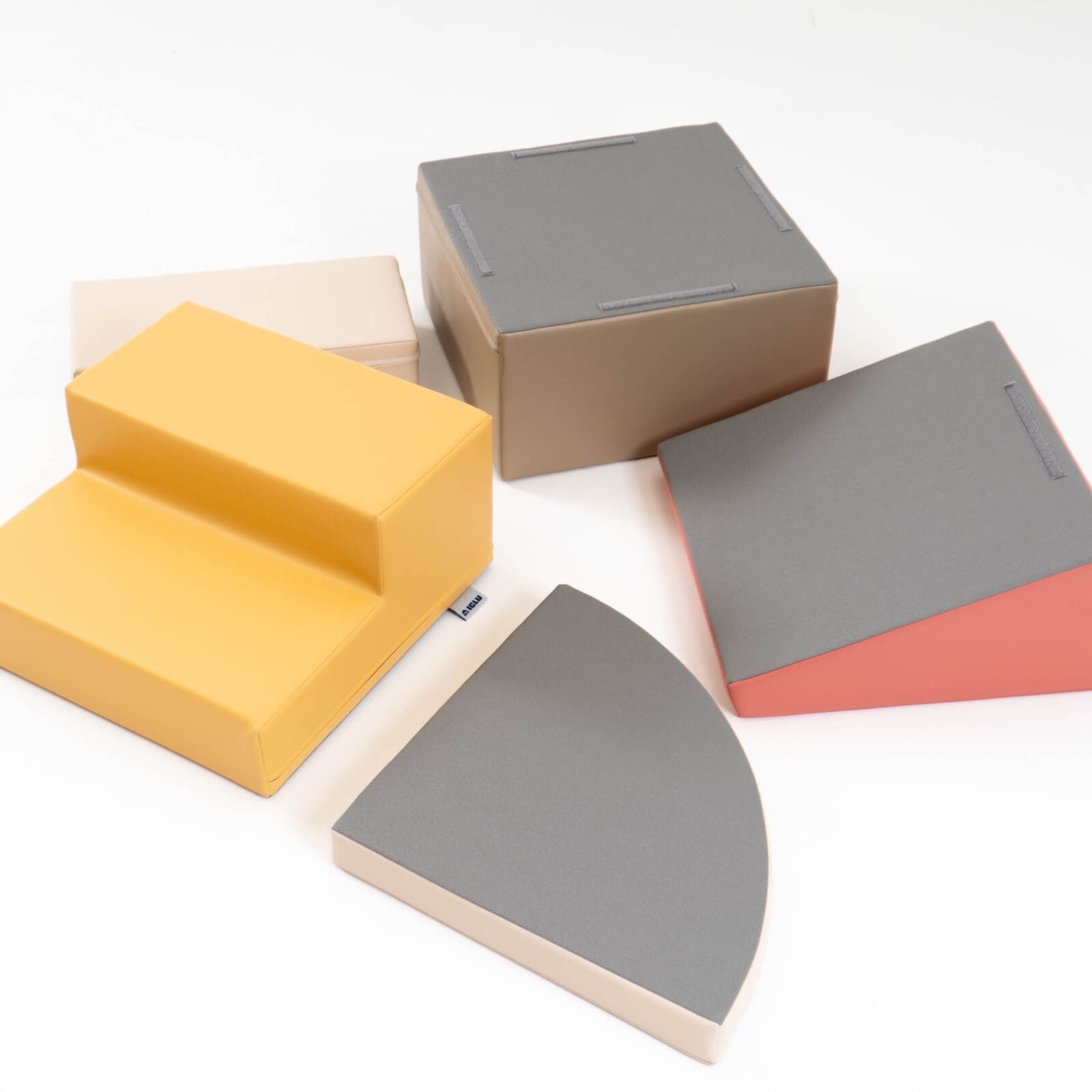 Five individual foam blocks displayed separately showing yellow steps, gray, beige, and pink pieces