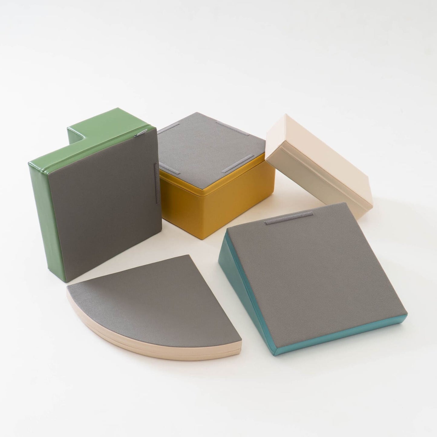 Individual foam blocks for IGLU corner climber set stacked and arranged in various configurations