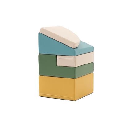 Stacked foam climbing blocks in turquoise, cream, green and gold showing stackable design