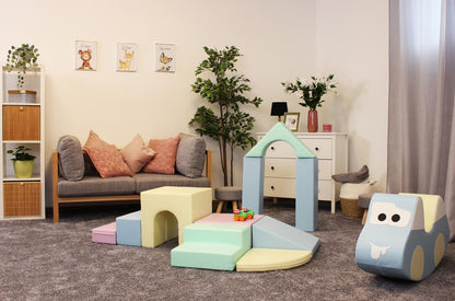Child's playroom with IGLU foam blocks arranged as structures near sofa and storage