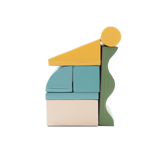 IGLU Discoverer foam block set stacked in tower formation with yellow ramp, turquoise blocks, and cream base