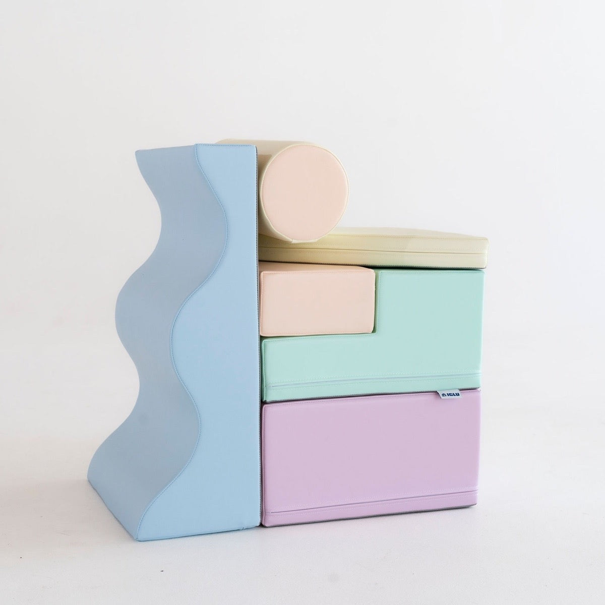 Toddler crawling on light pastel foam blocks in living room playspace