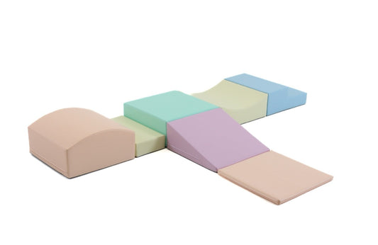 Seven-piece IGLU foam block set in light pastel colors arranged in a cross pattern