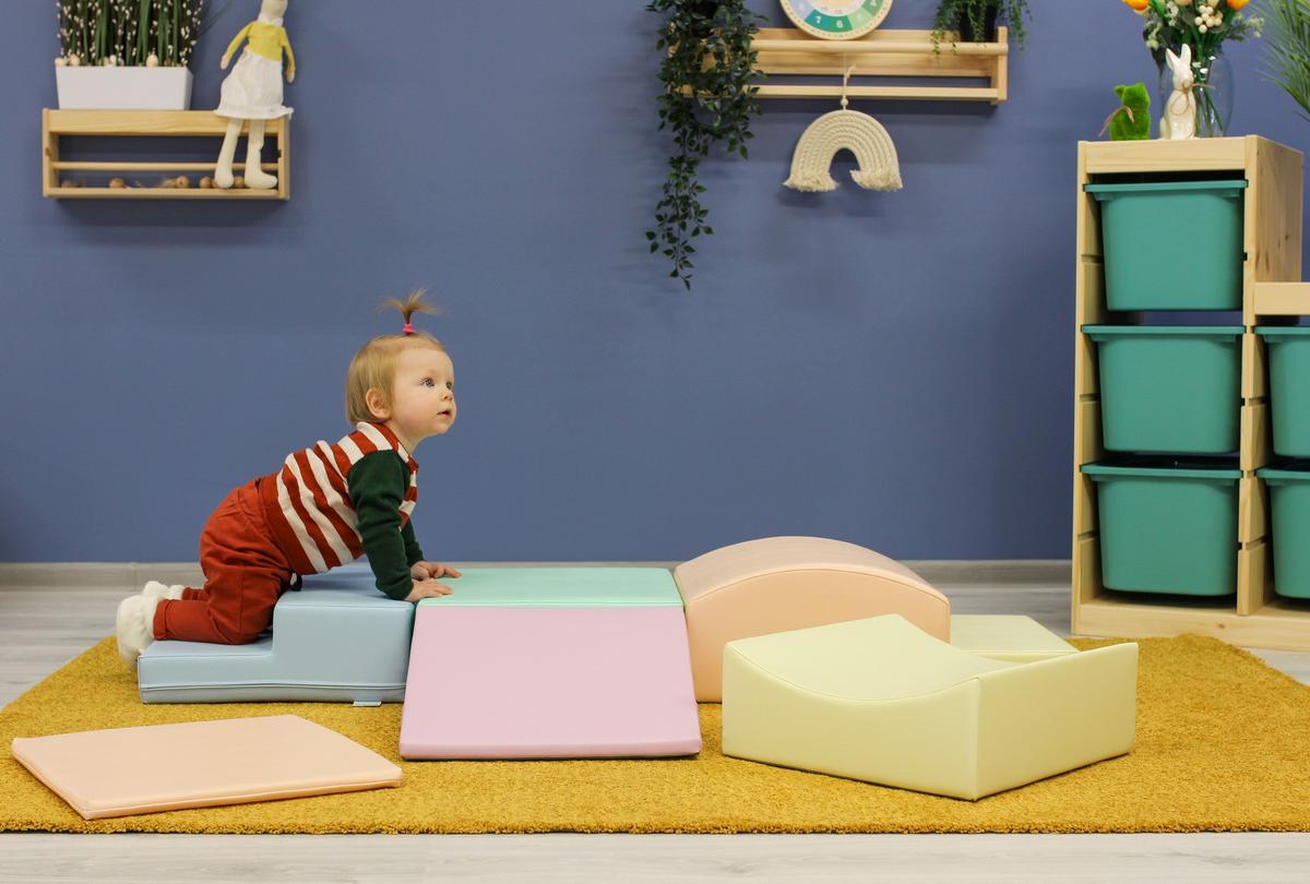 Stacked pastel foam blocks in light pink, mint, cream, and yellow arranged vertically
