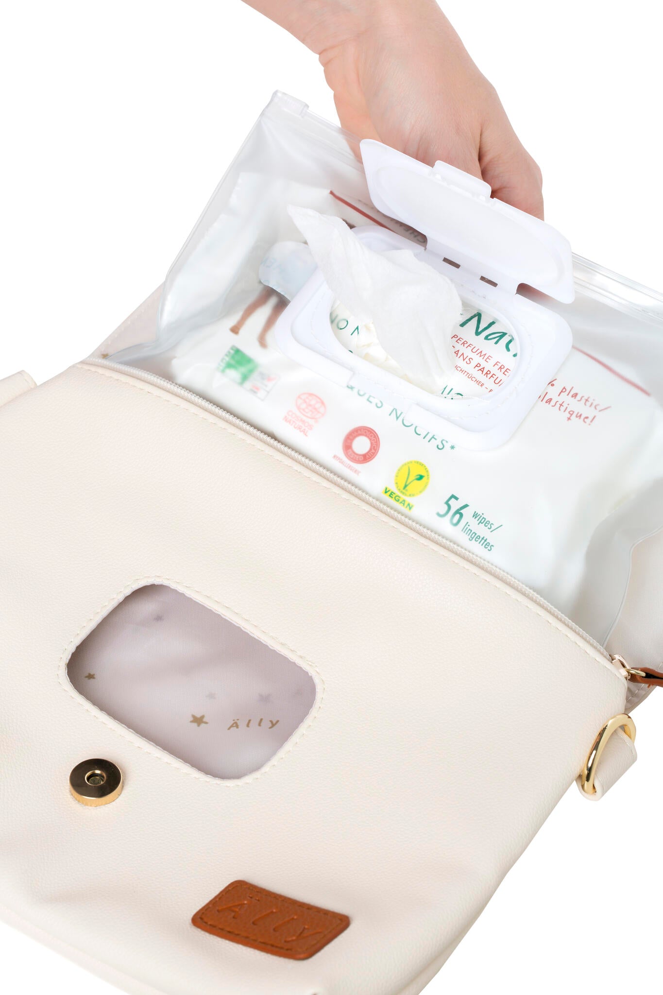 Cappuccino handbag with included accessories and changing supplies on display