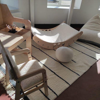Two-tone lamb fleece bean bag in playroom with wooden toy frame