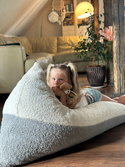 Young child nestled in soft sherpa bean bag with comfort and support