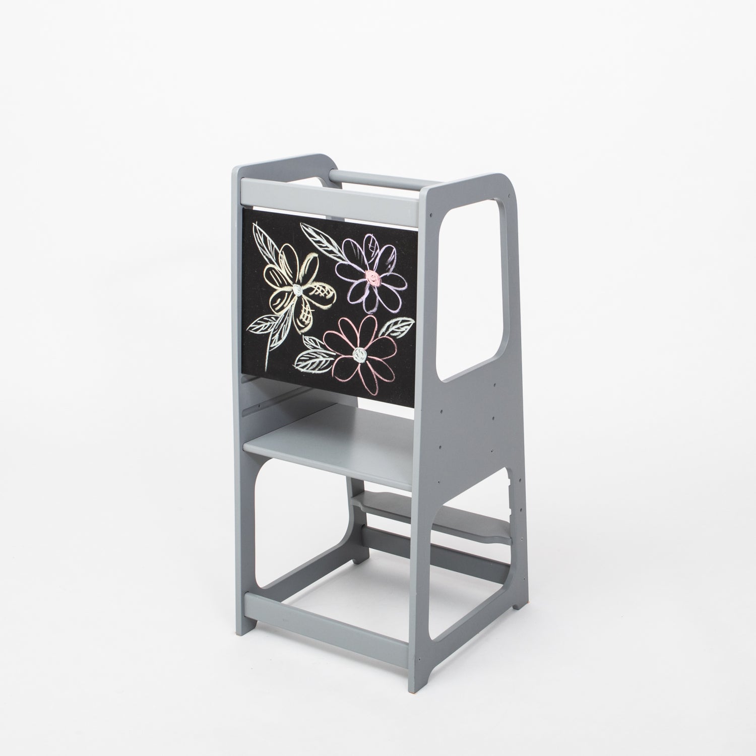 Gray wooden kitchen helper tower with blackboard panel featuring flower chalk drawings