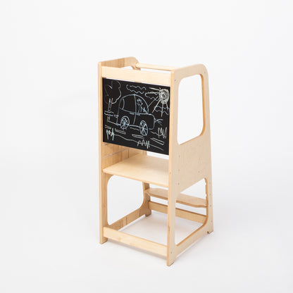 Natural birch kitchen tower with blackboard panel displaying children's car sketches