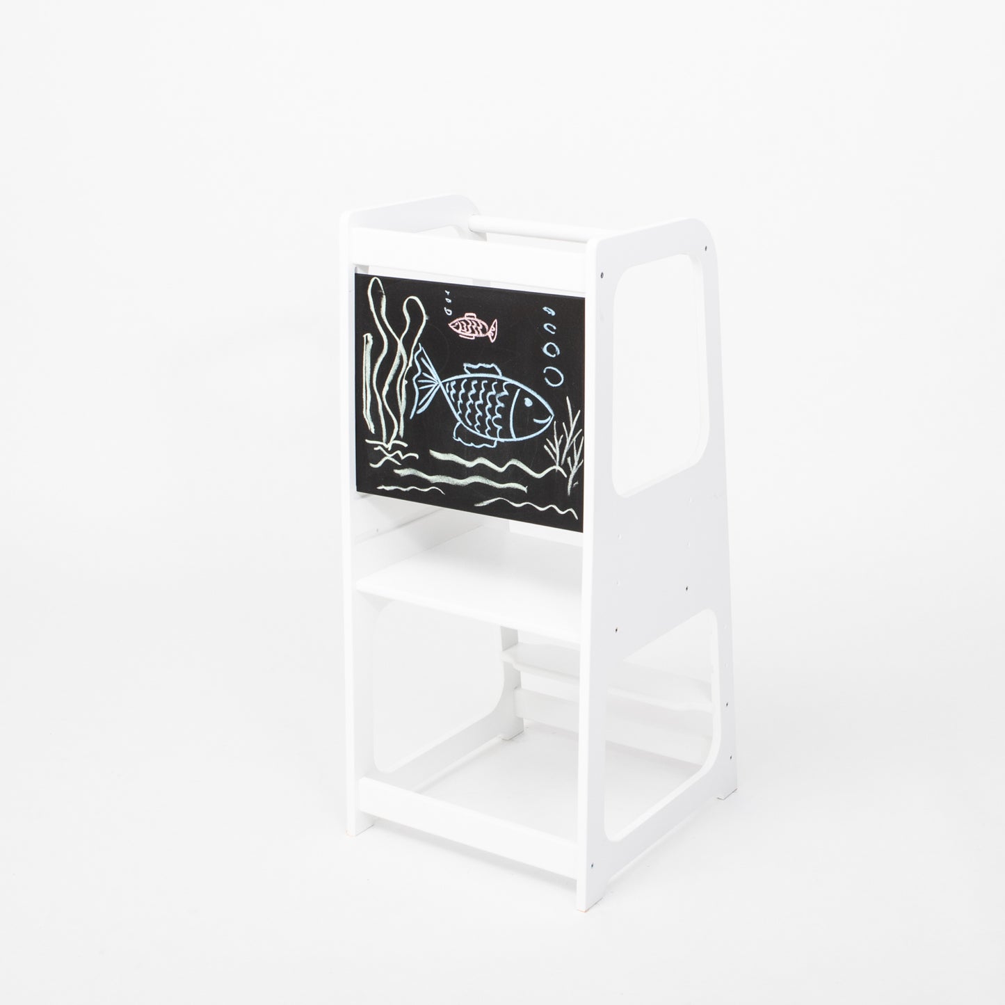 White wooden kitchen helper tower with blackboard panel showing ocean scene chalk art