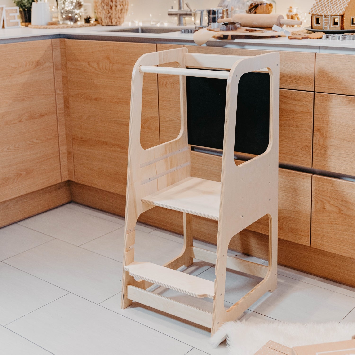 Natural wood kitchen helper tower with blackboard panel and safety rails