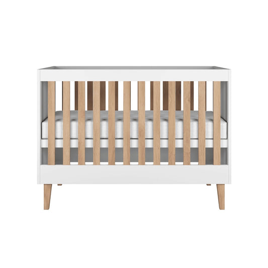 Kocot Kids Baby Bed Kubi White Scandinavian Crib – front view white wooden cot with oak legs | Nestling