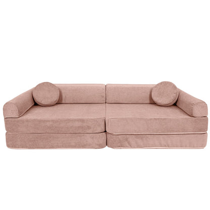 Pink modular kids sofa assembled in couch configuration with round arm pillows