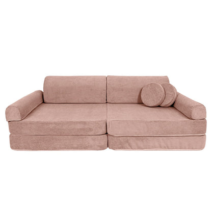 Pink modular kids sofa with extended seat cushion and round side pillow accent