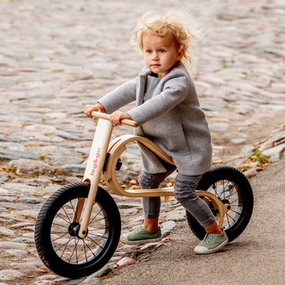 Young toddler sitting on leg&go 3in1 wooden kids bike – size and scale reference for ages 1–3
