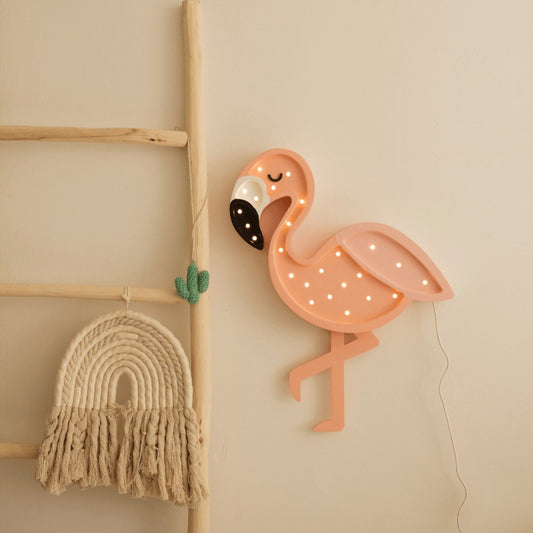 Pink flamingo LED lamp with warm white lights displayed on bedroom wall next to macramé decor