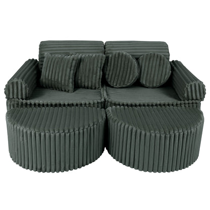 Forest green modular kids sofa with ribbed corduroy texture and round ottoman poufs, showing adjustable seating configuration