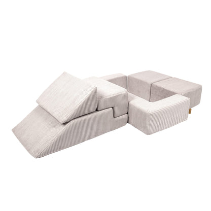 Ecru velvet bricks configured in sofa formation with open ball pit compartment