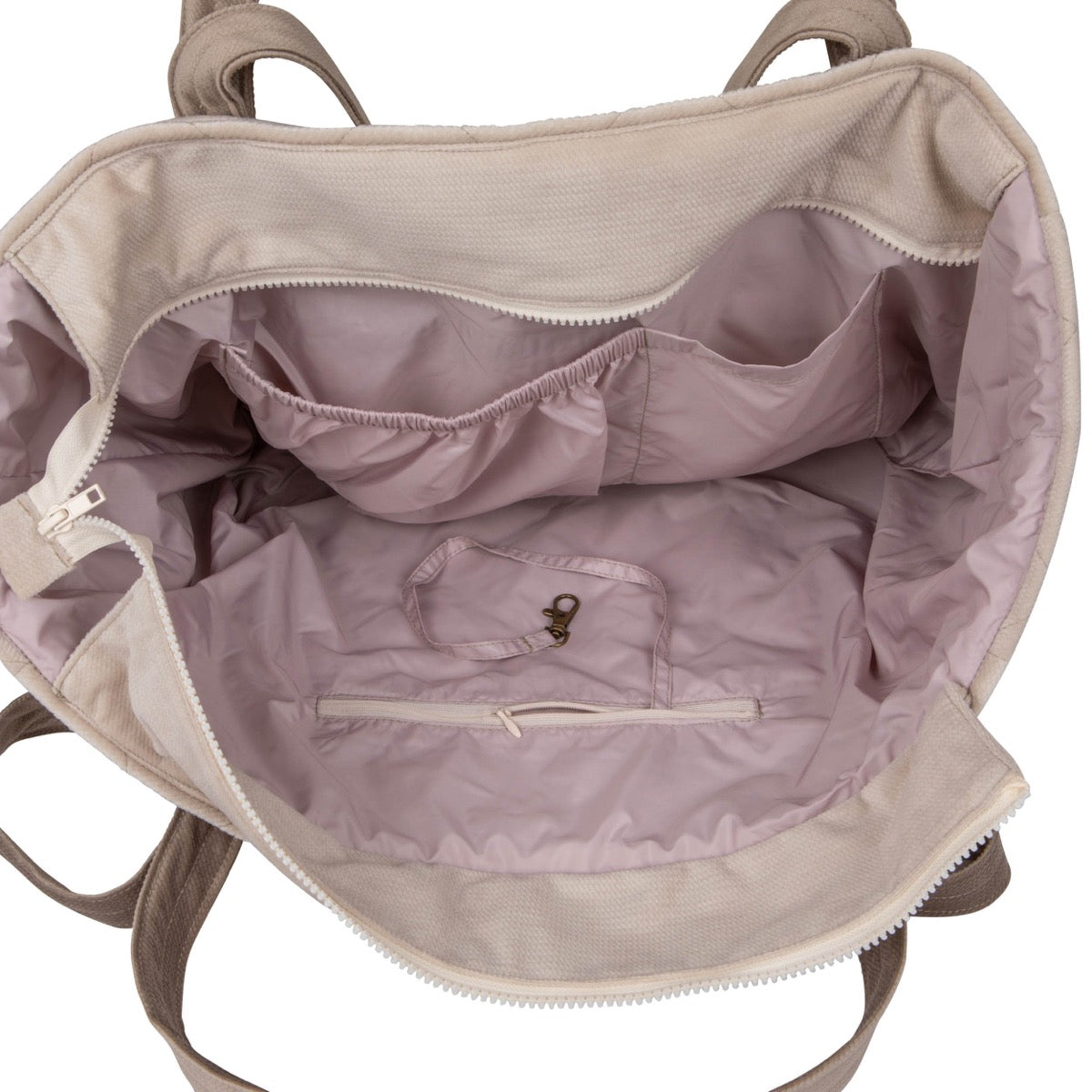 Interior view of beige weekender bag displaying waterproof lining and organized pocket compartments