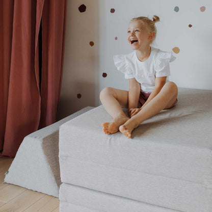 Happy Child Sitting on Monboxy Activity Play Mattress Set Beige – Nestling