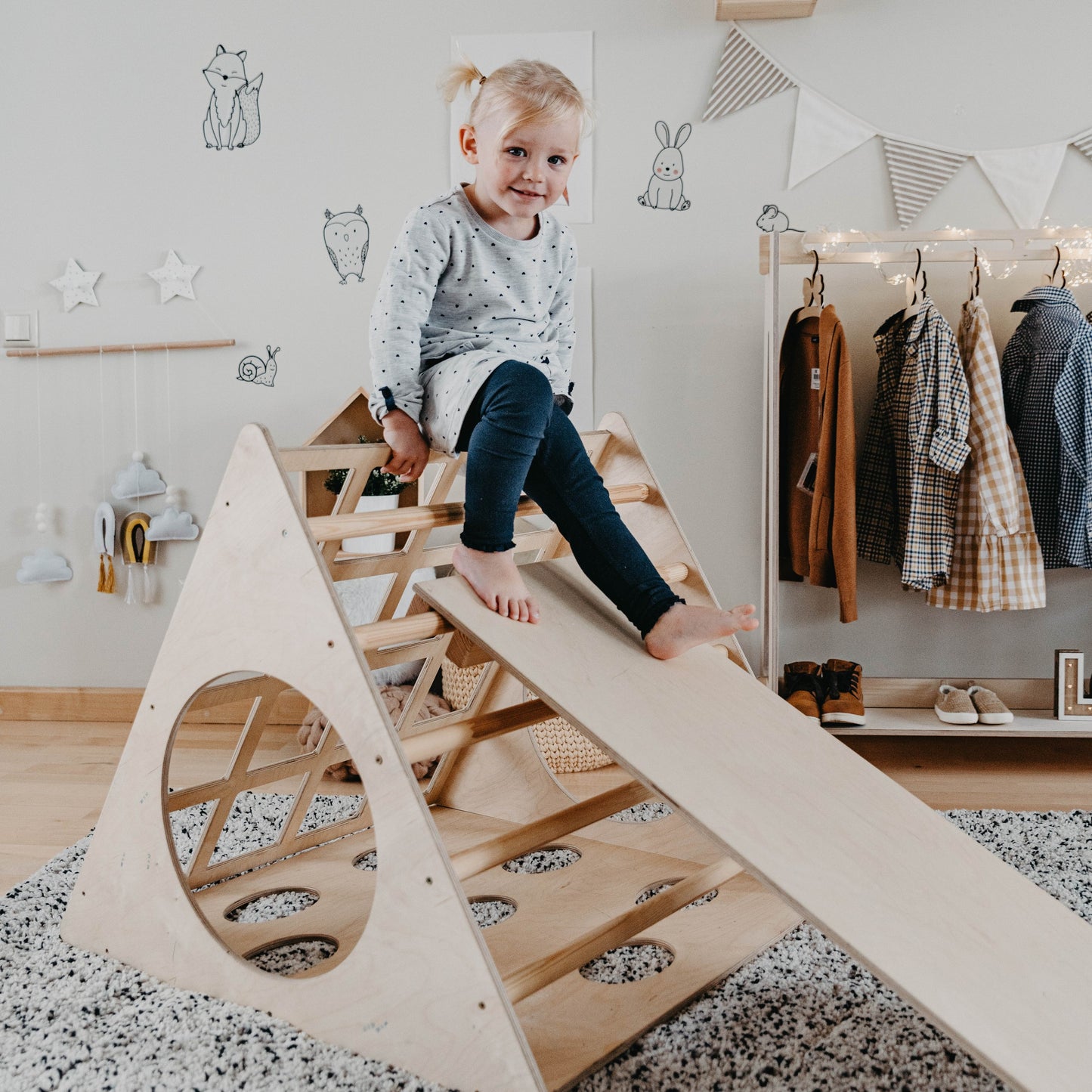 Toddler climbing and sliding on birch wood 3-angle climbing triangle with ramp in Montessori bedroom
