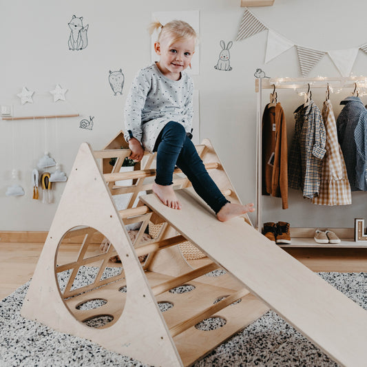 Toddler climbing and sliding on birch wood 3-angle climbing triangle with ramp in Montessori bedroom