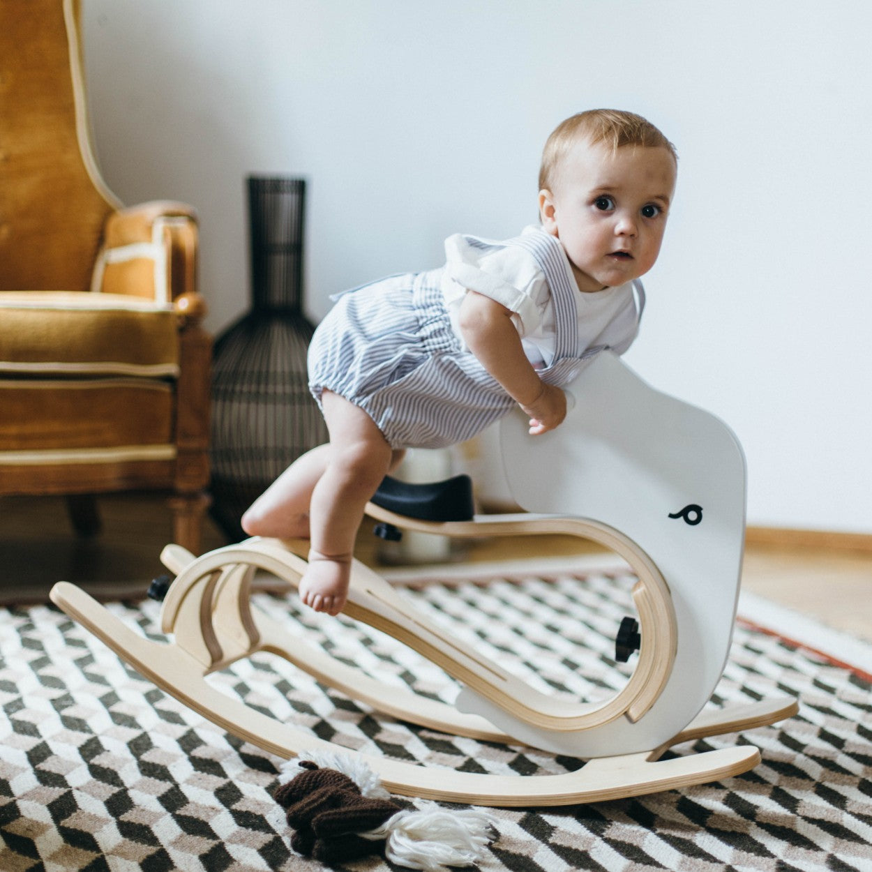 Child climbing onto rocking elephant add-on showing easy backrest-free mounting design