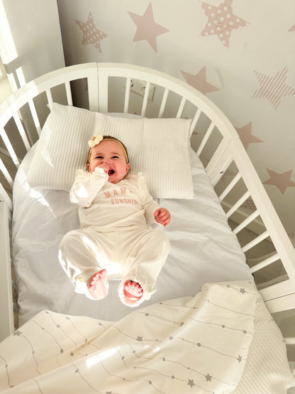 White round crib OLIN three-quarter view with two adjustable mattress height positions