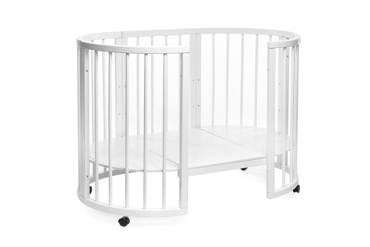 White beech wood round crib in convertible mode showing split gate opening feature