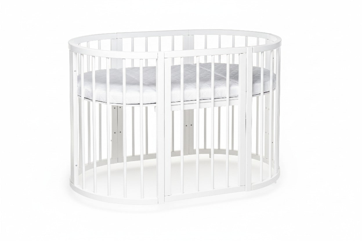 KOTTO round crib with two vertical slat sections displaying modular conversion capability