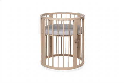 Compact circular OLIN crib with locking wheels and fully removable side panel