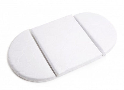 White oval mattress pad designed for round crib with three sections