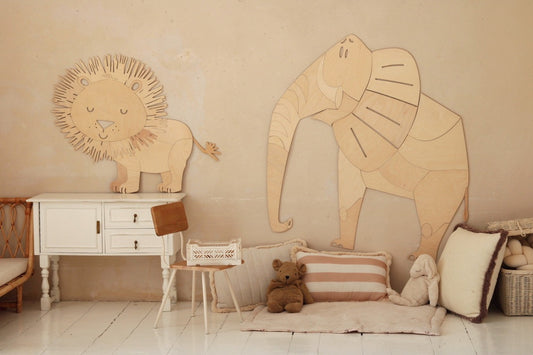 Wooden safari lion and elephant wall decor displayed in neutral nursery room setting