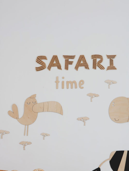 Safari Time wooden wall decoration with toucan, lion, and baobab tree elements assembled on white wall