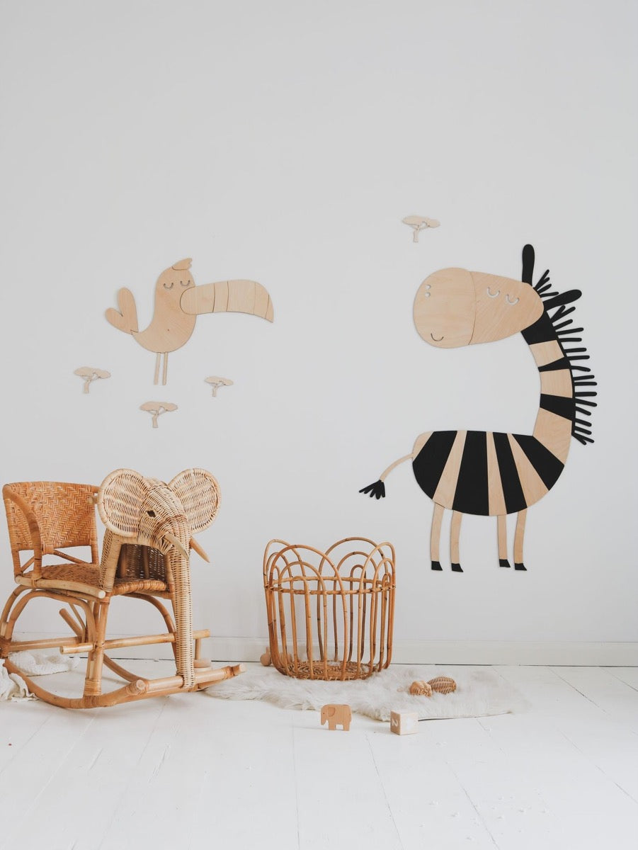 Flat lay of wooden safari animal wall decals showing zebra, lion, and bird pieces