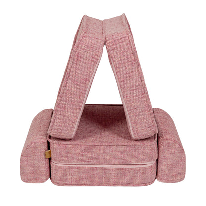 Bubblegum pink modular sofa with handle carrier straps for easy transport and storage