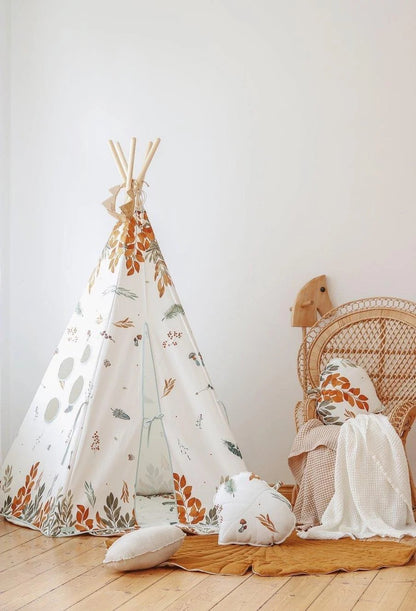 Full view of assembled moi mili teepee tent with forest-themed cotton fabric and matching pillows