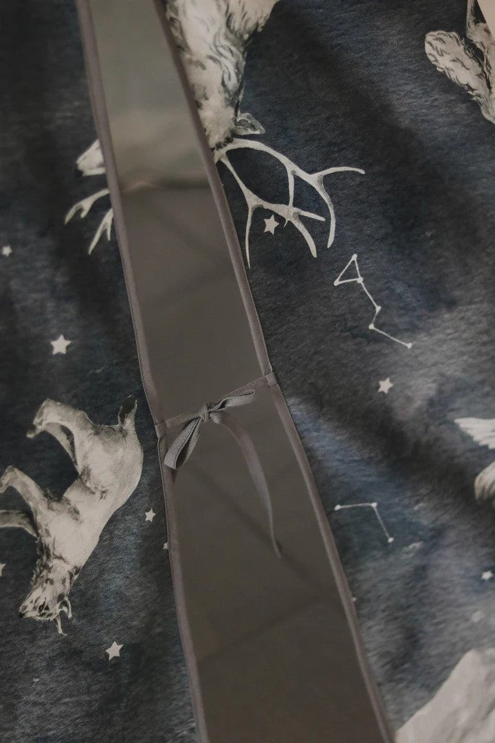 Detailed shot of Night Sky teepee fabric showing embroidered animal and star motifs on cotton