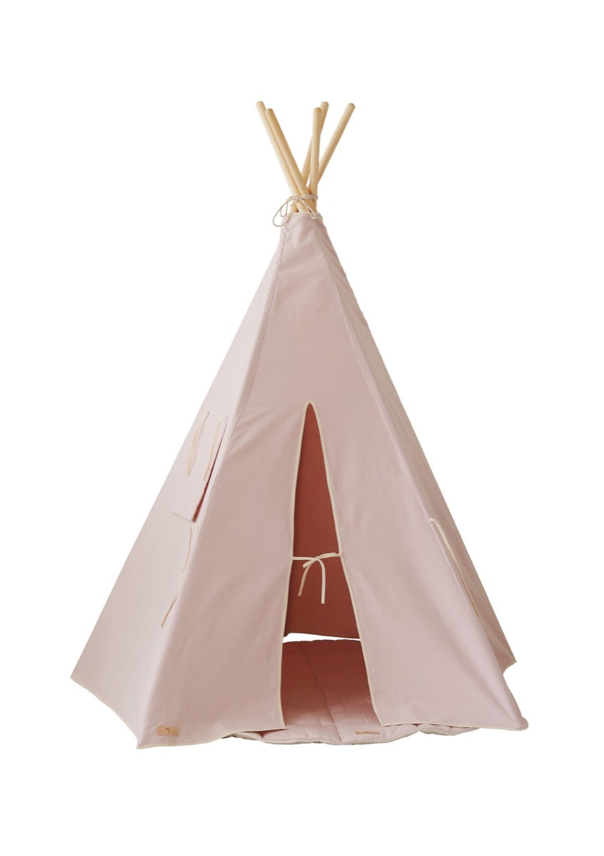 Full view of pink cotton teepee tent with sturdy pine pole frame against white background