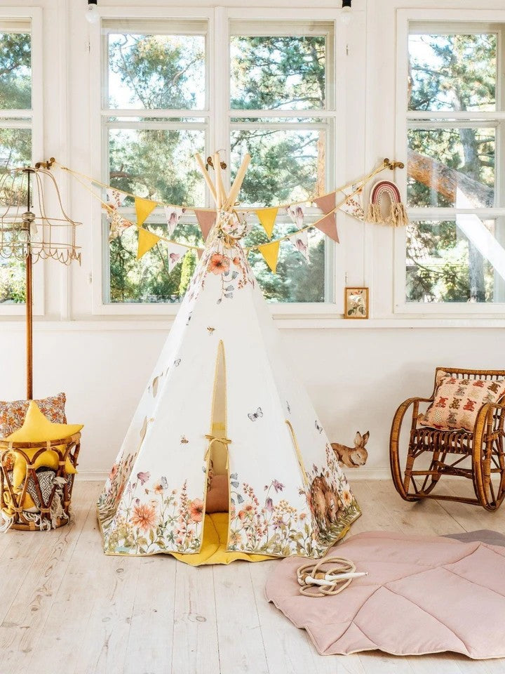 Front view of Wildflowers cotton teepee showing floral design with deer and bees, wooden poles and entrance