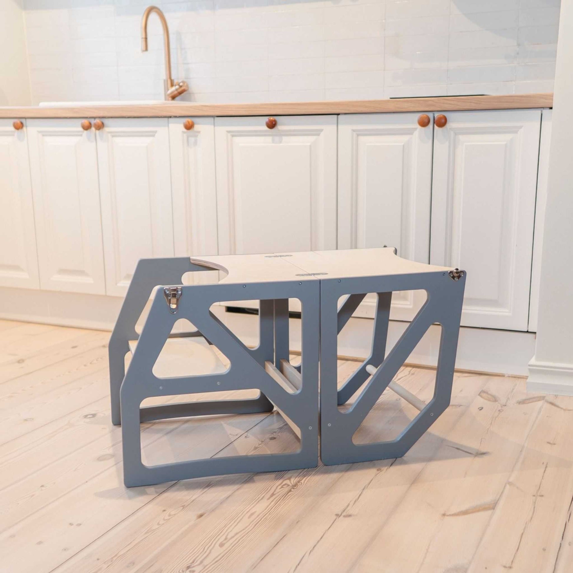 Blue-gray transformable kitchen tower folded flat as table and chair configuration