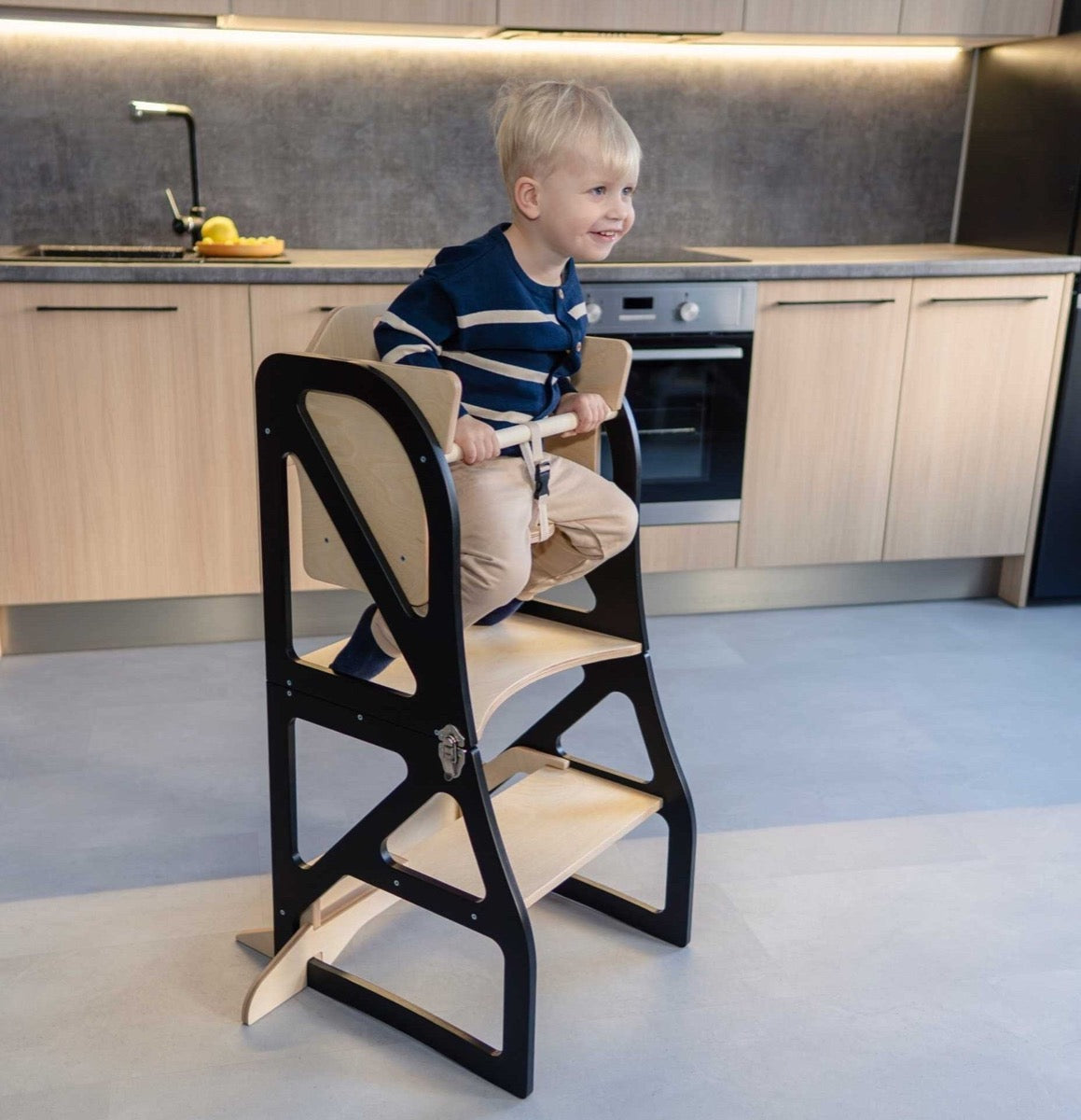 Gray kitchen tower with attached table showing high chair back detail
