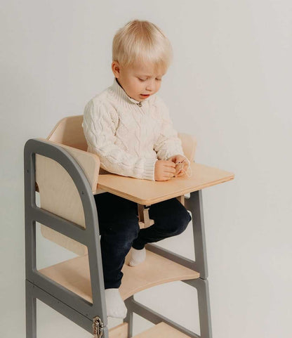 Child using natural kitchen tower for safe counter-height kitchen access