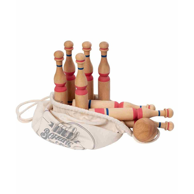Wooden bowling set with 10 pins and 2 balls partially packed into canvas drawstring storage bag