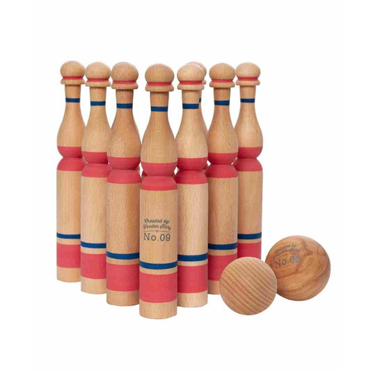 Ten wooden bowling pins with red and navy bands and two wooden balls arranged in classic setup formation