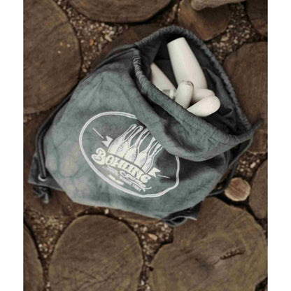 Wooden bowling pins and ball packed in navy canvas storage bag