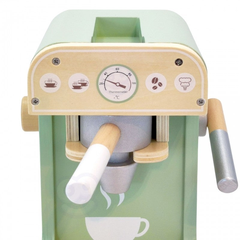 Wooden barista set displayed on couch showing coffee maker with coffee disk storage compartment open
