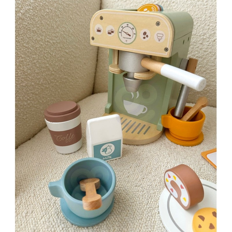 Wooden coffee maker positioned next to milk carton, cups, and pastry cookies during active play session